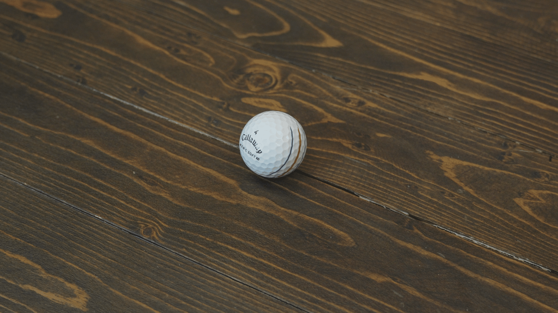 Golf ball on wooden floor