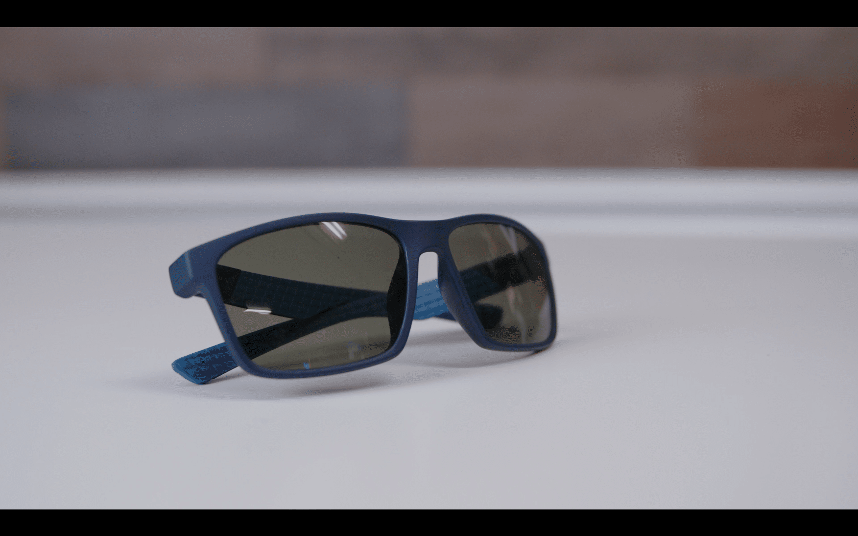 Blue sunglasses on white surface