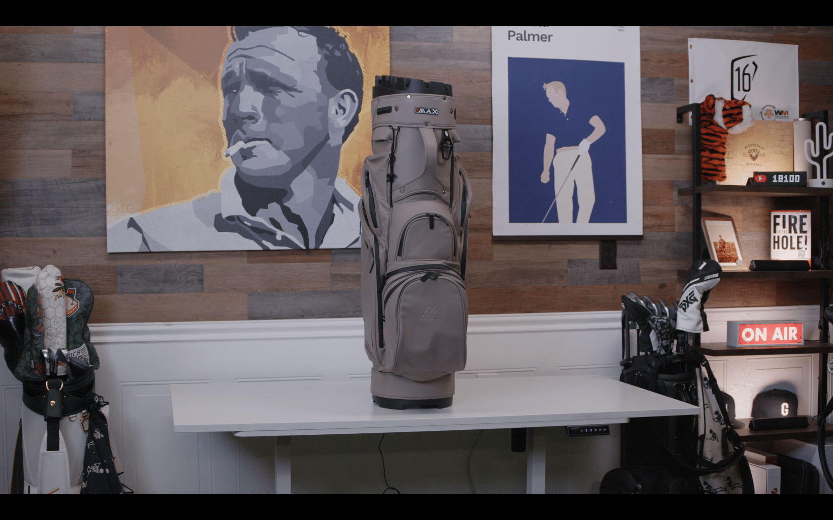 Gray golf bag on white table indoors