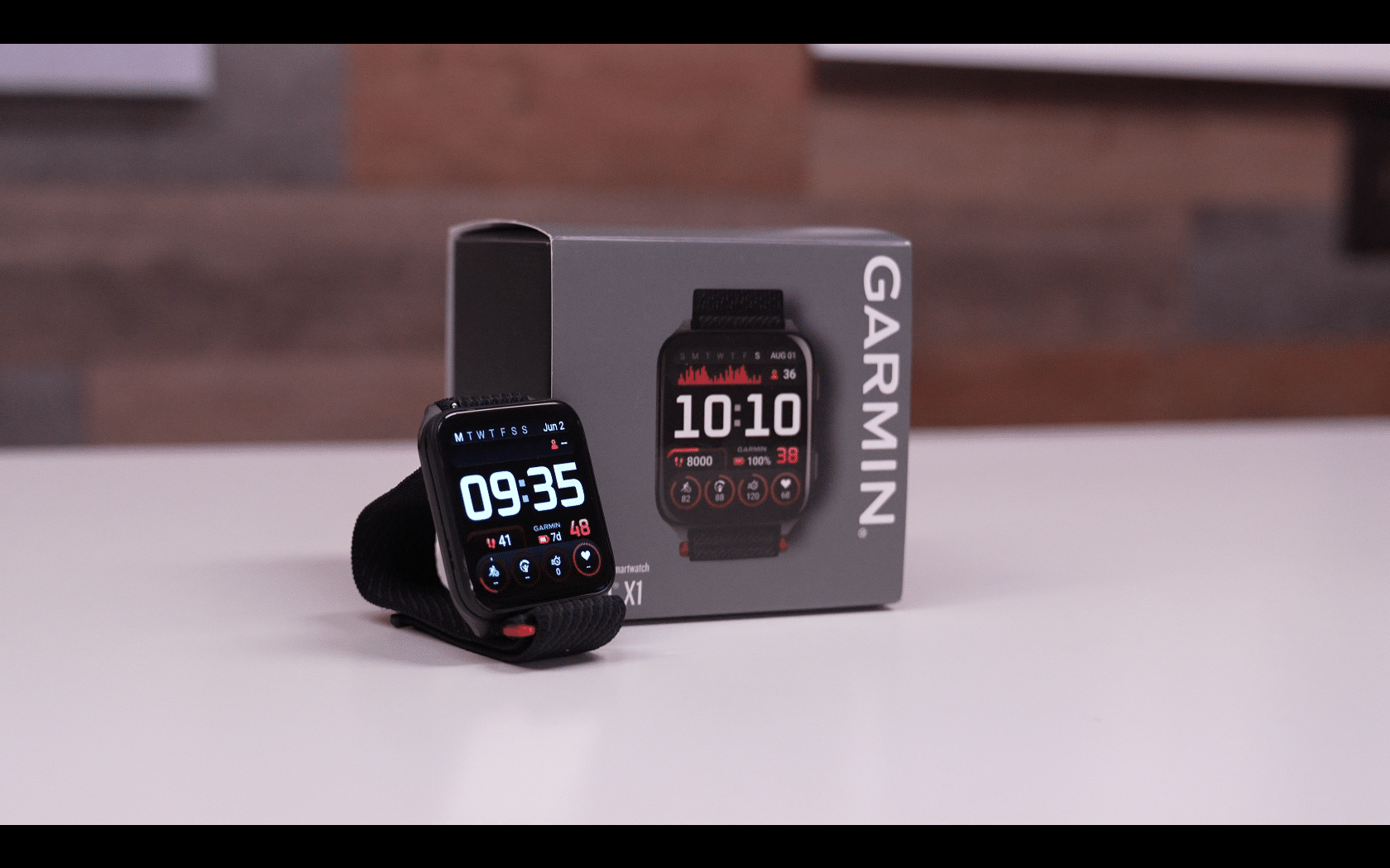 Garmin smartwatch displayed beside its packaging box