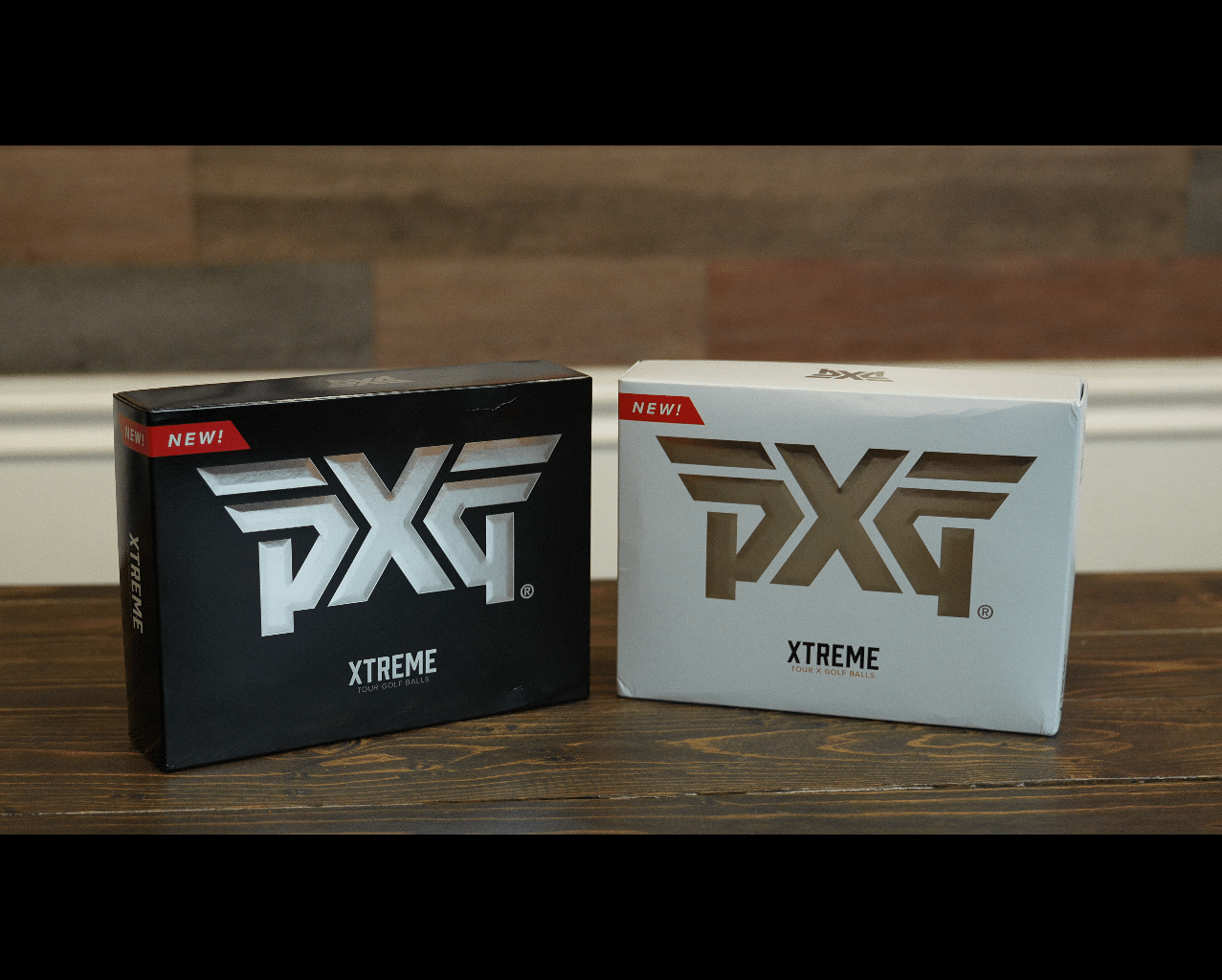 PXG Xtreme golf ball boxes on wooden table