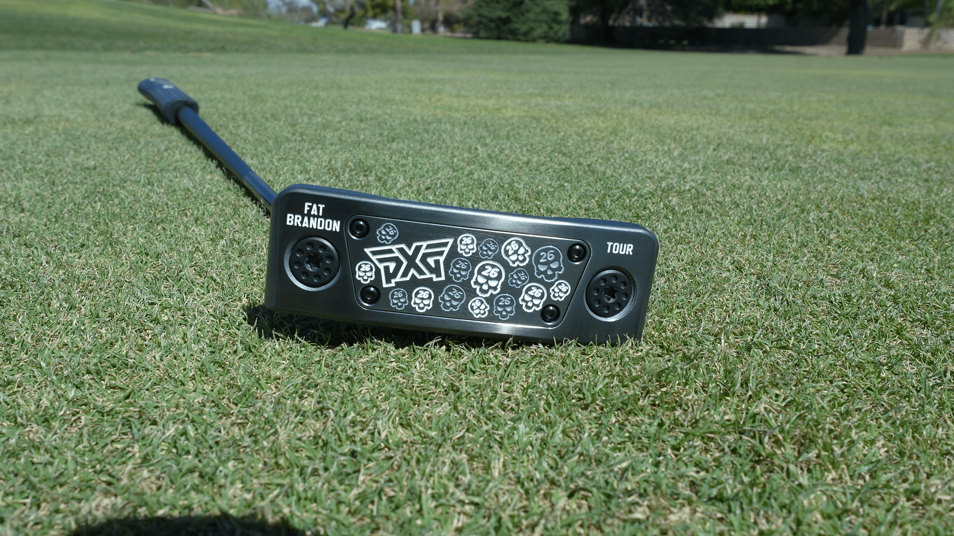 PXG golf putter on grass course
