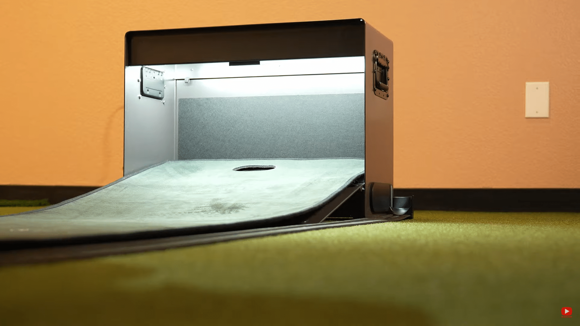 Indoor golf putting practice machine on green mat