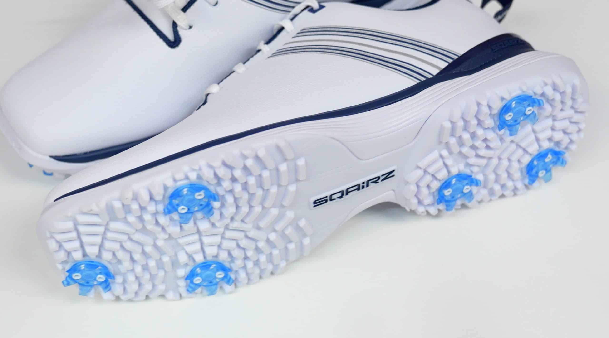 White golf shoes with blue traction spikes
