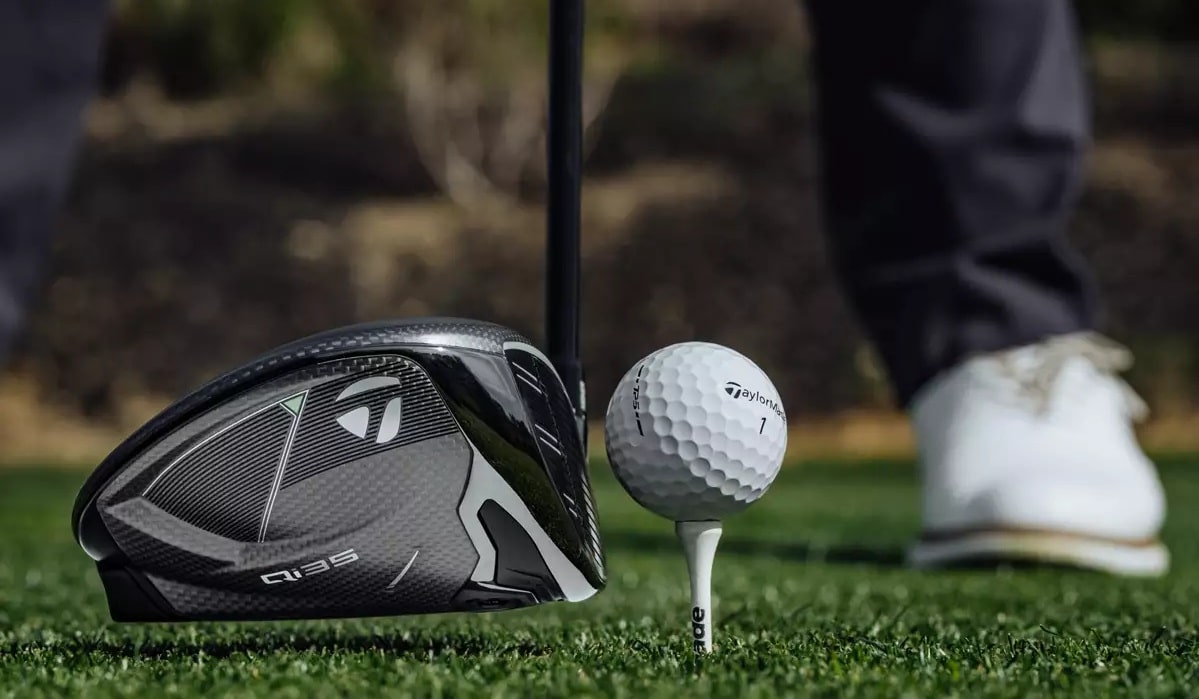 Golf driver next to a golf ball on tee