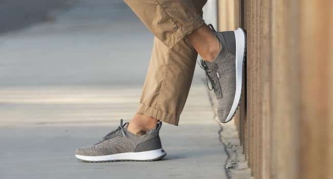 Person wearing gray sneakers and khaki pants