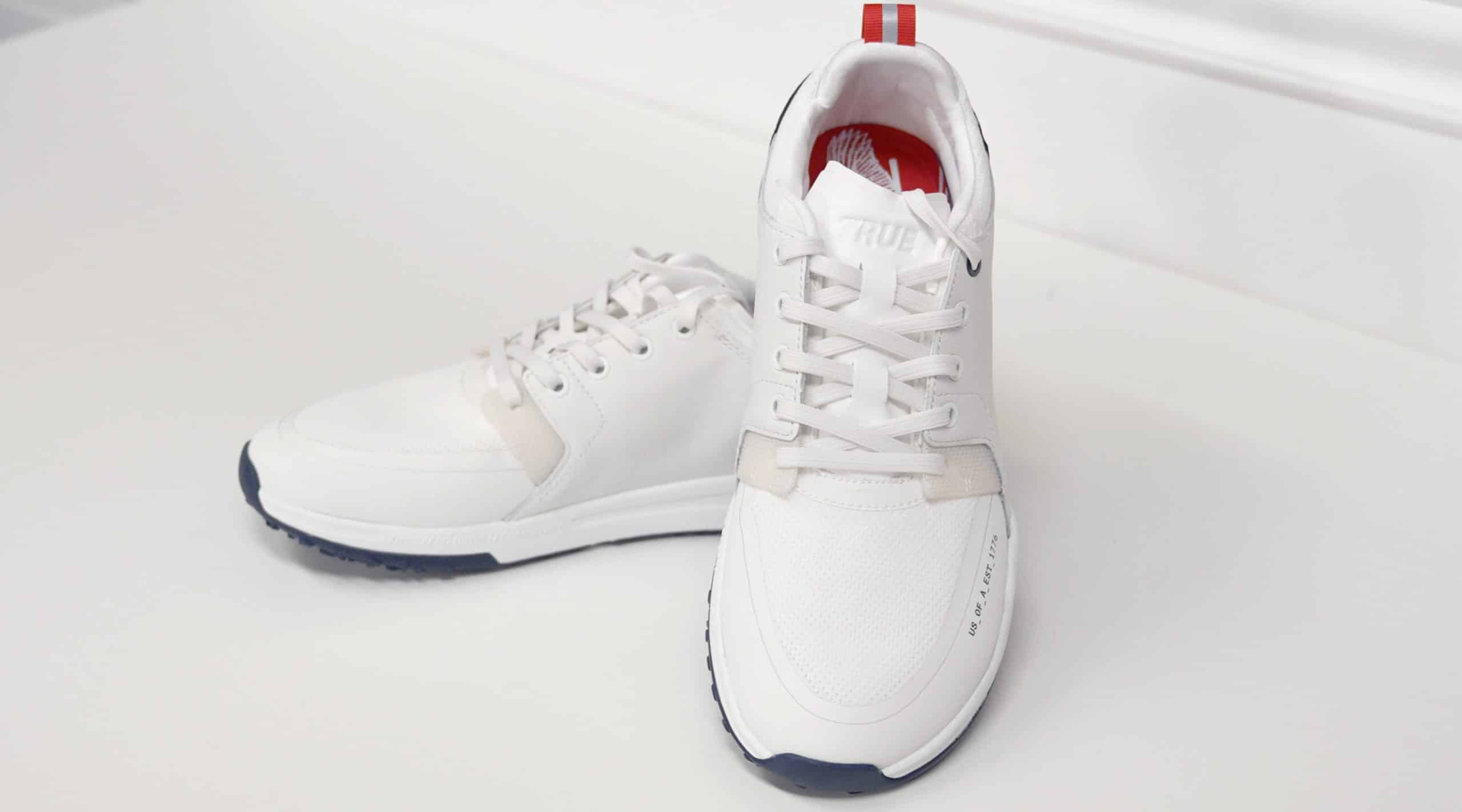 White athletic sneakers on white surface