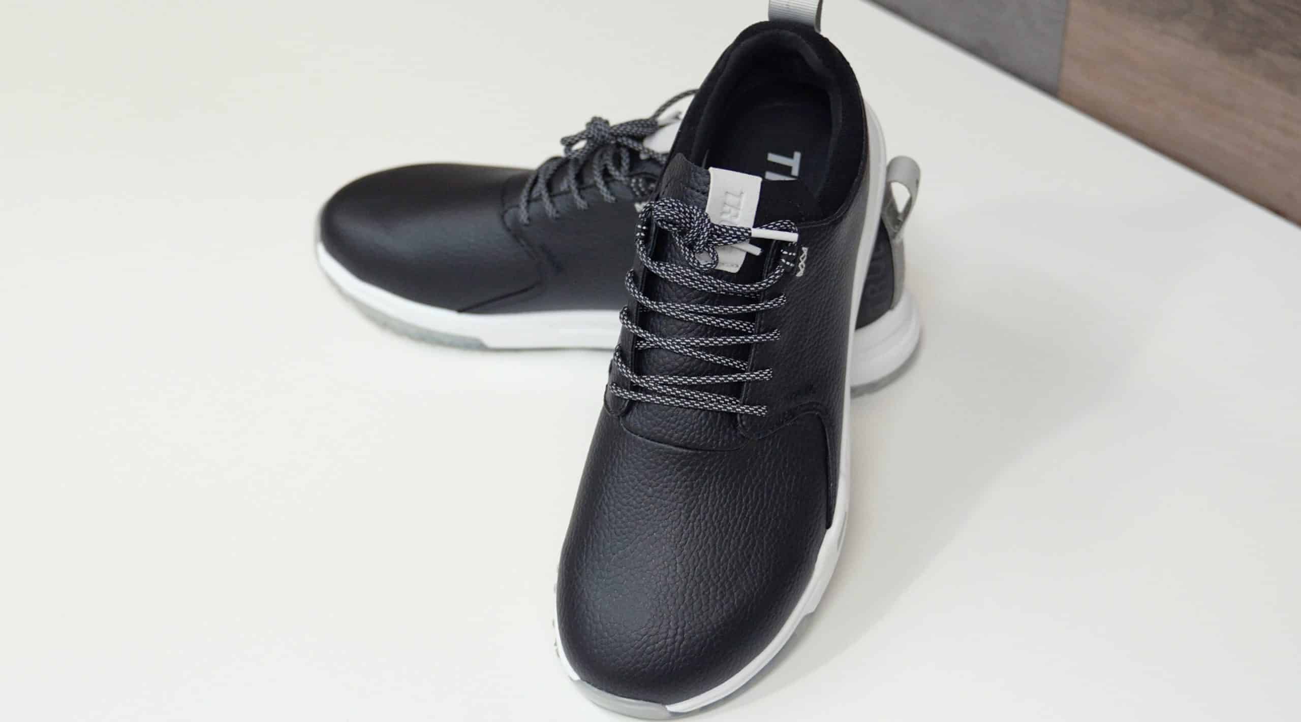 Black leather sneakers with white soles