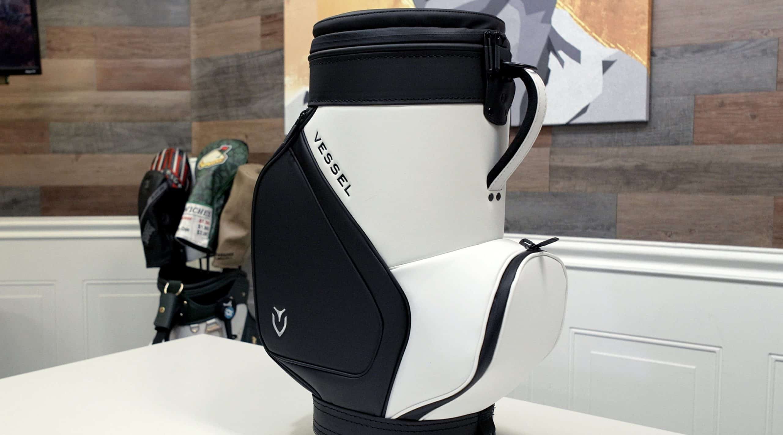 White and black Vessel golf bag on table
