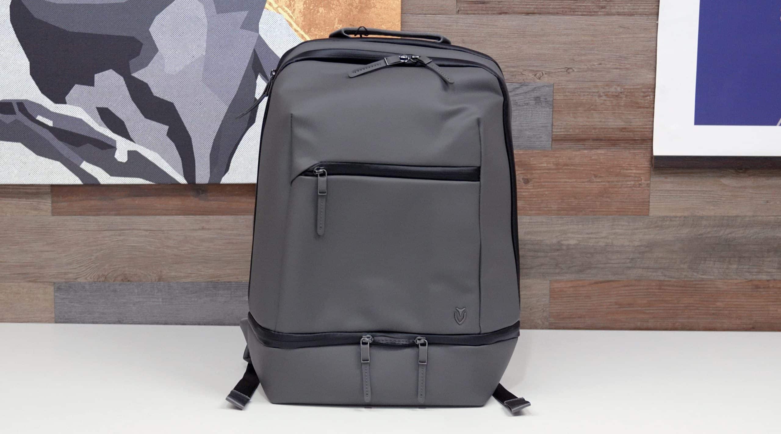 Modern gray backpack on wooden background
