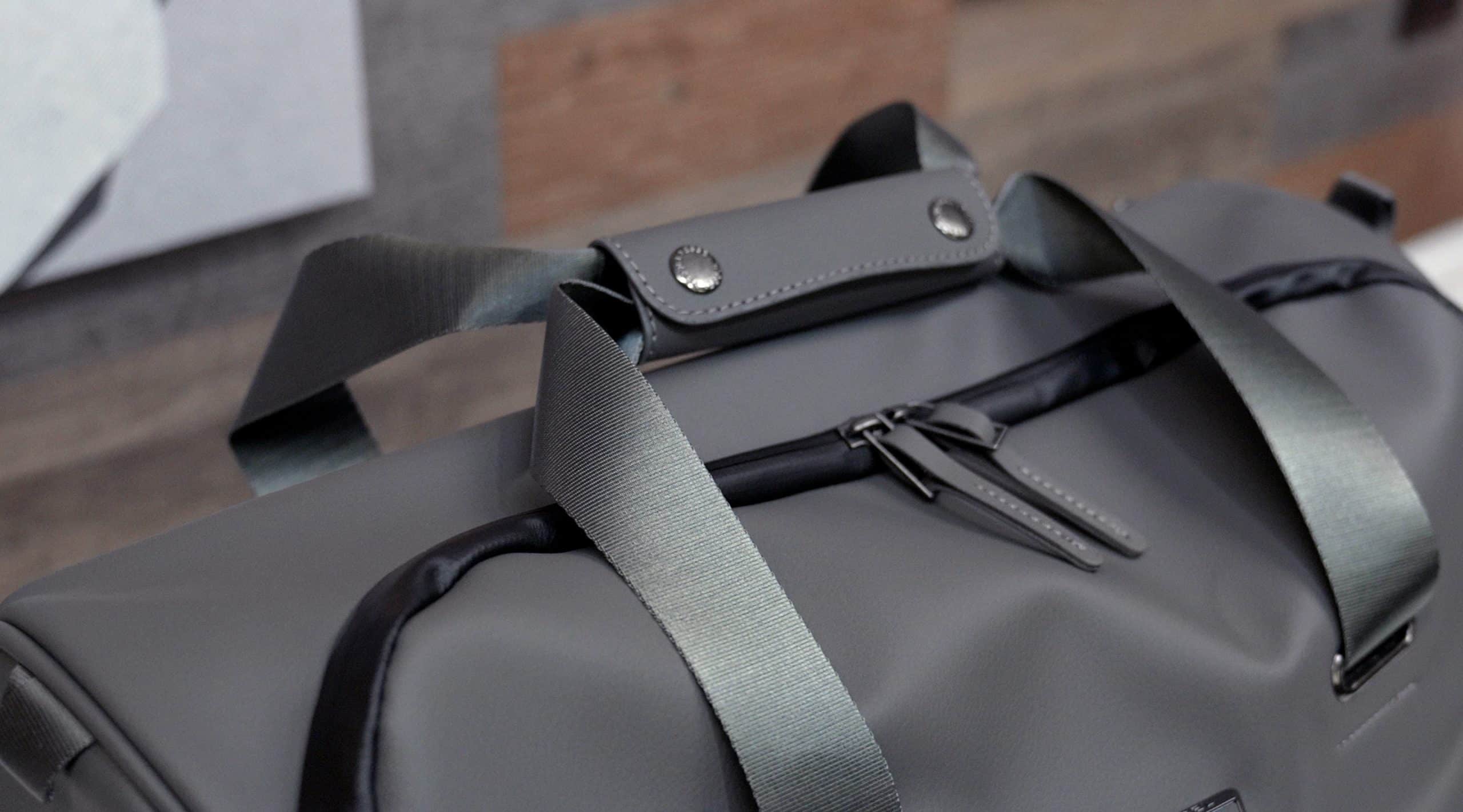 Gray duffel bag with black straps