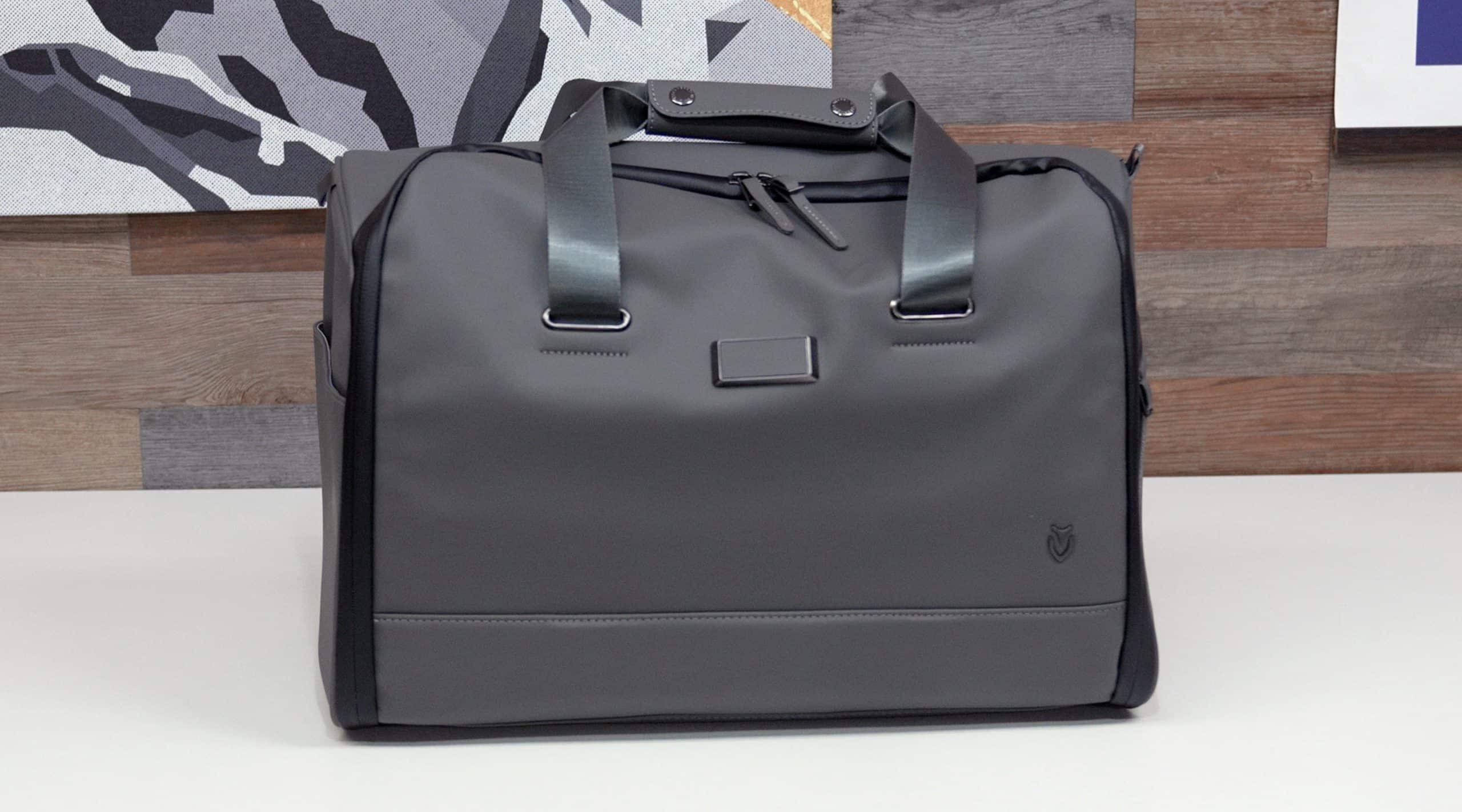 Gray duffel bag on white surface