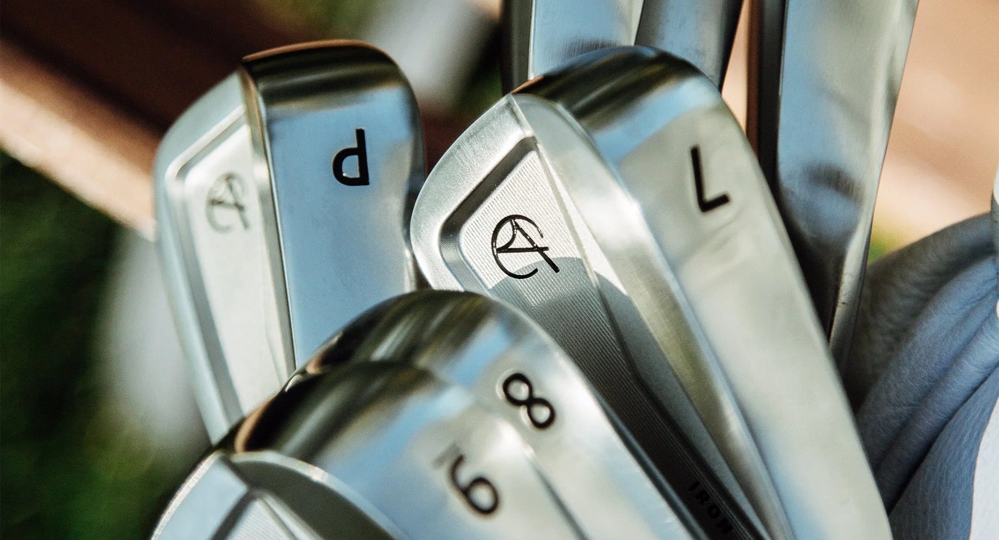 Close-up of shiny golf irons in bag
