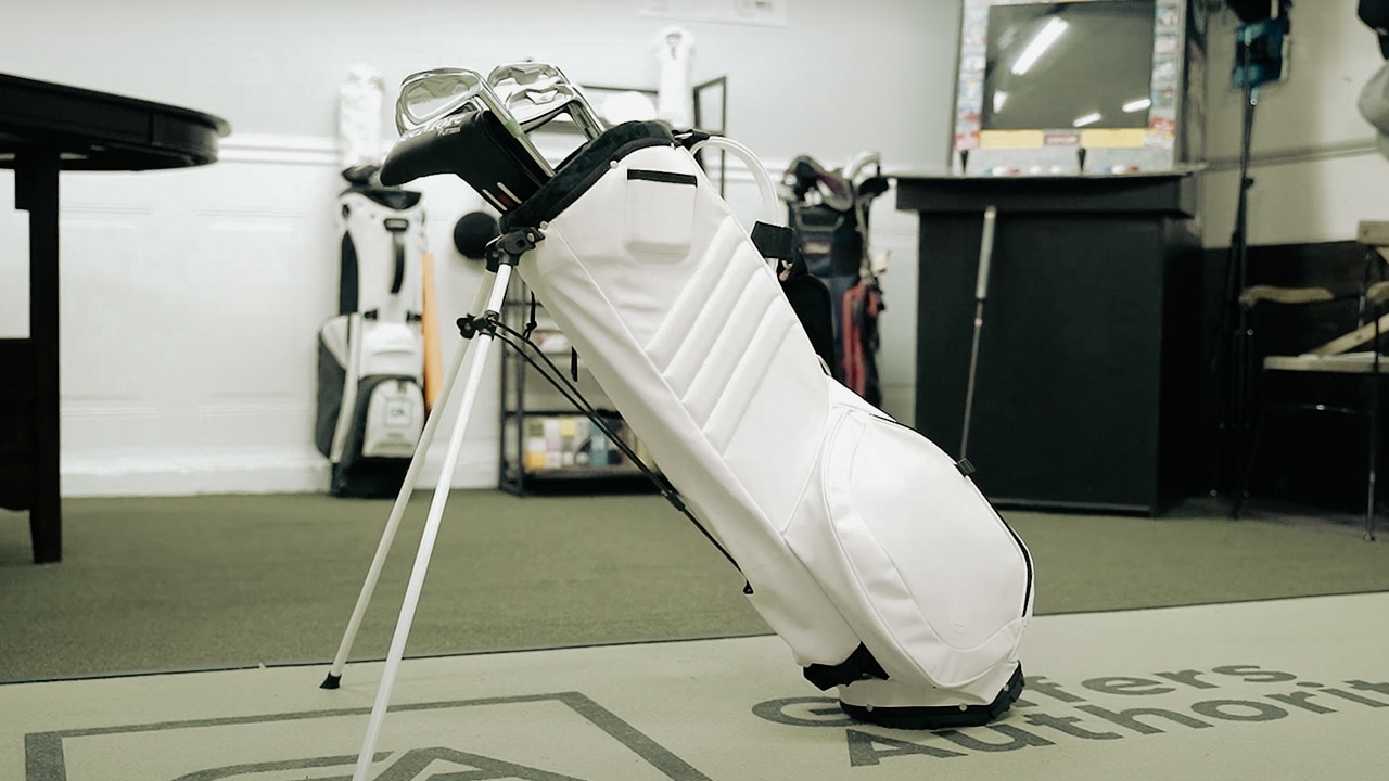 White golf bag with clubs indoors