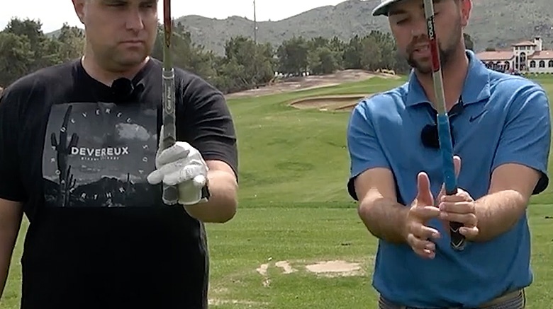 Golf instructor teaching grip technique on course