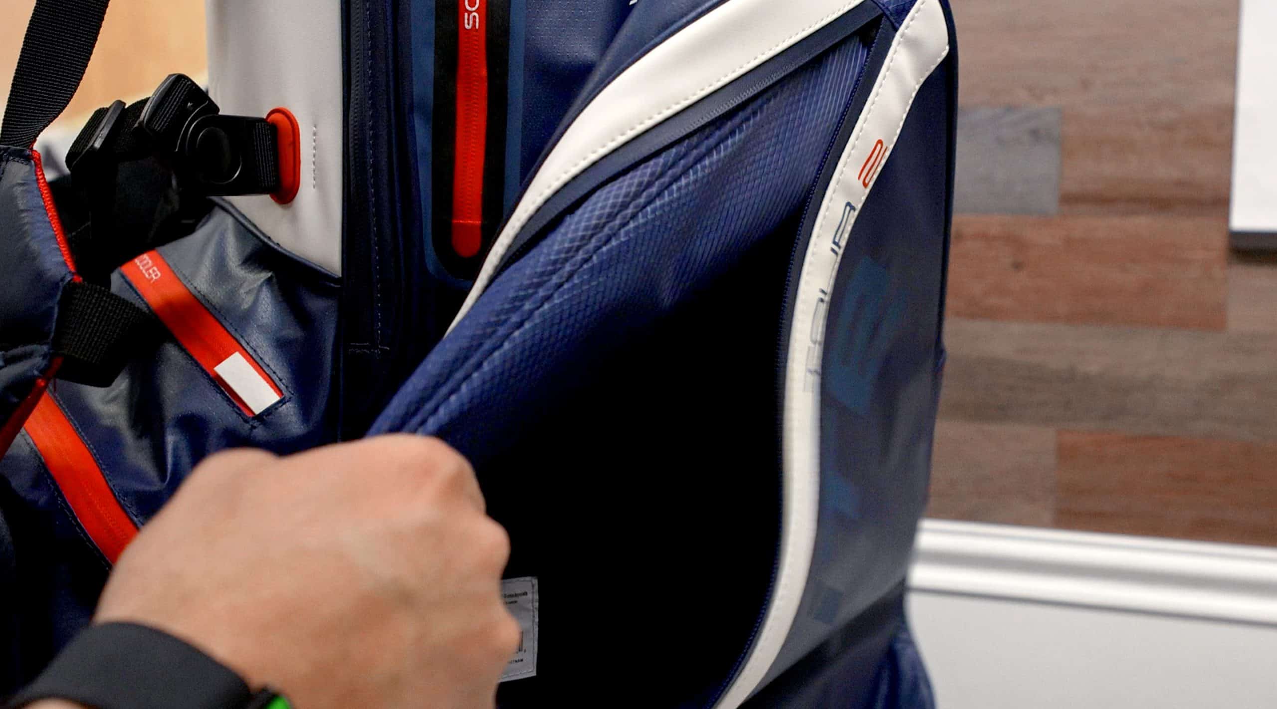 Person opening a blue sports bag pocket