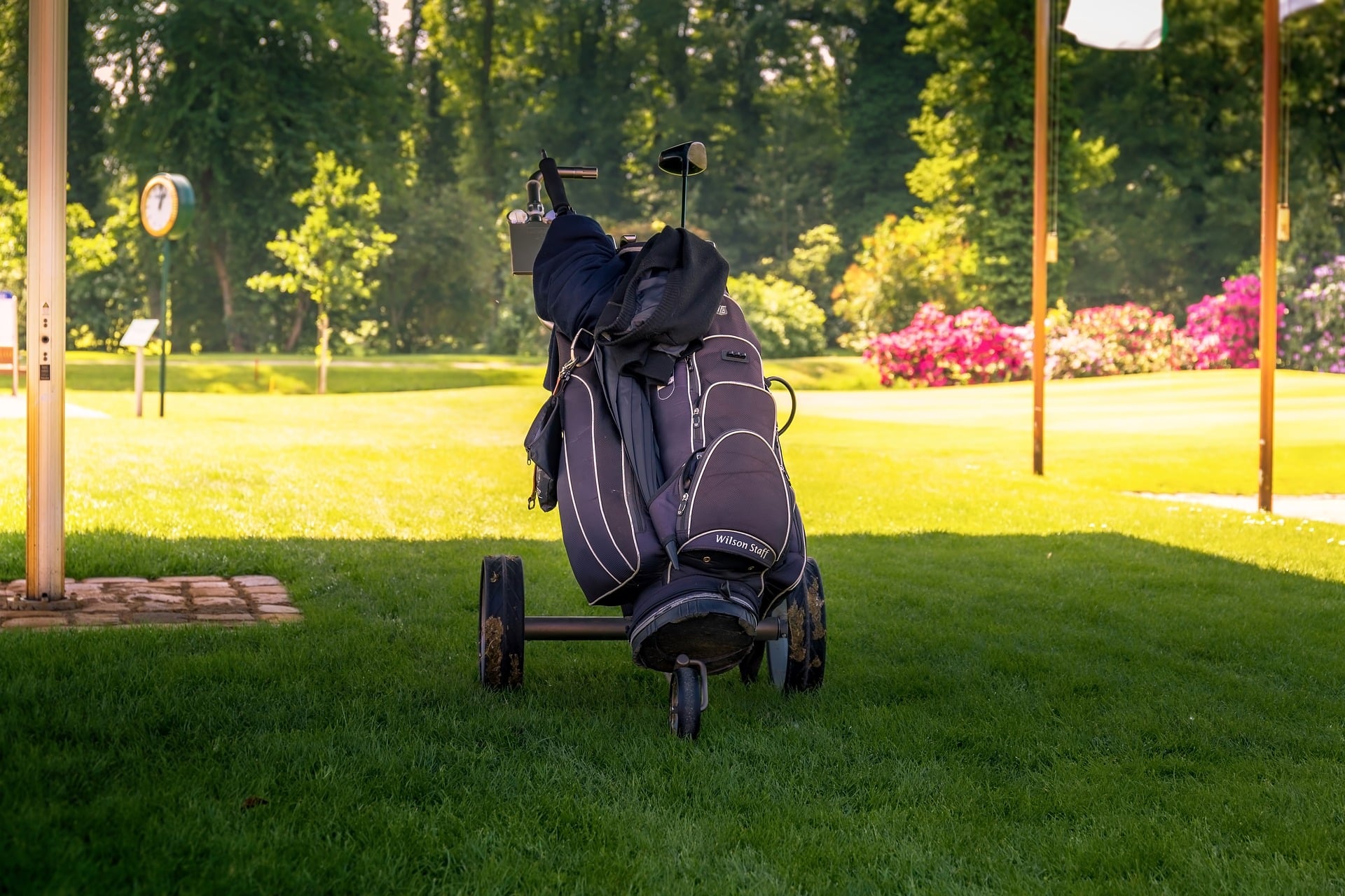 Golf bag on cart at sunny golf course