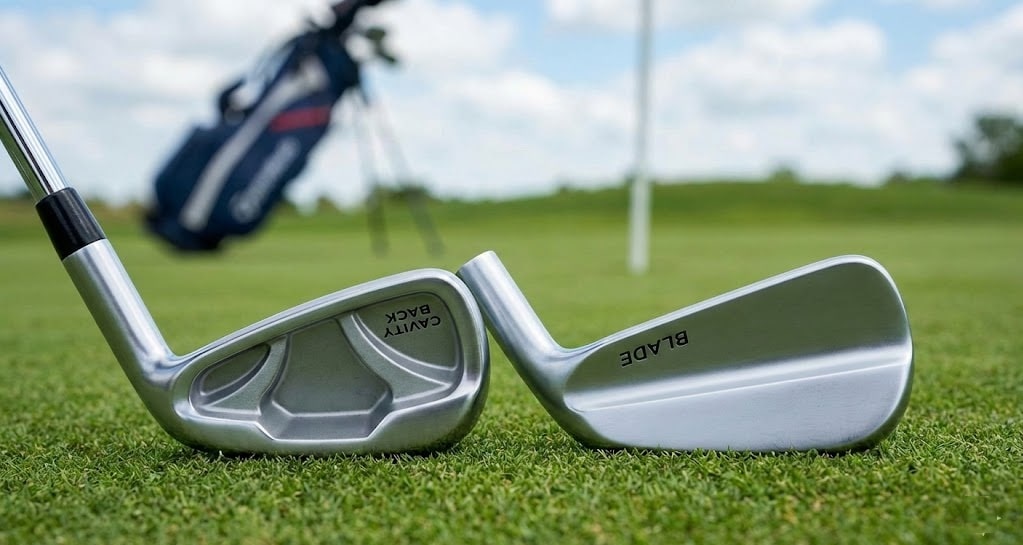 Golf irons on grass near golf bag