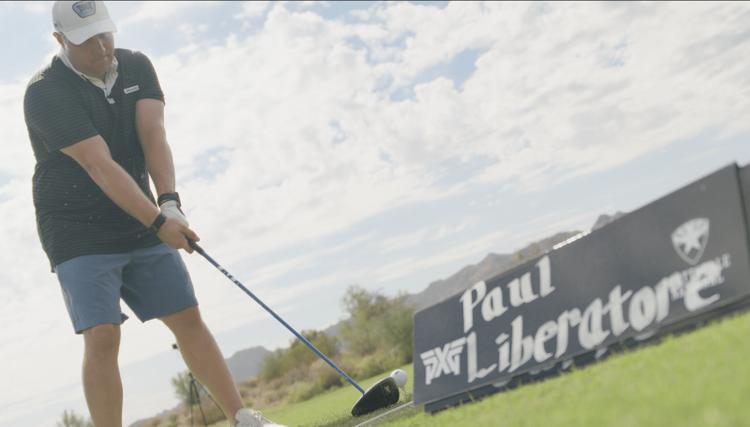 Golfer preparing to swing on a sunny course
