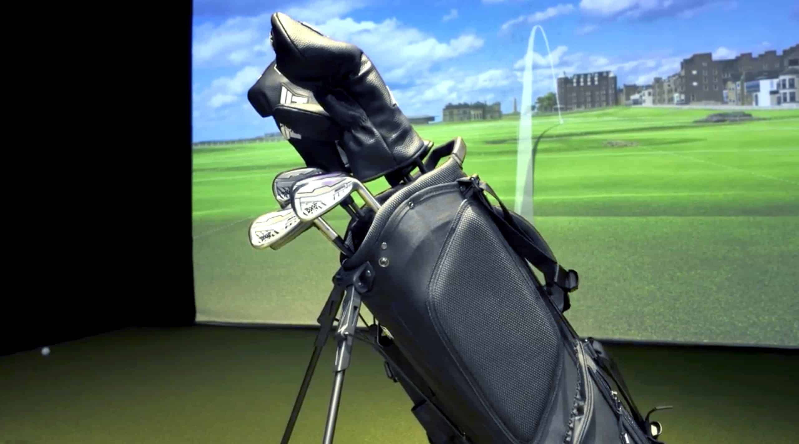 Golf bag with clubs in indoor simulator