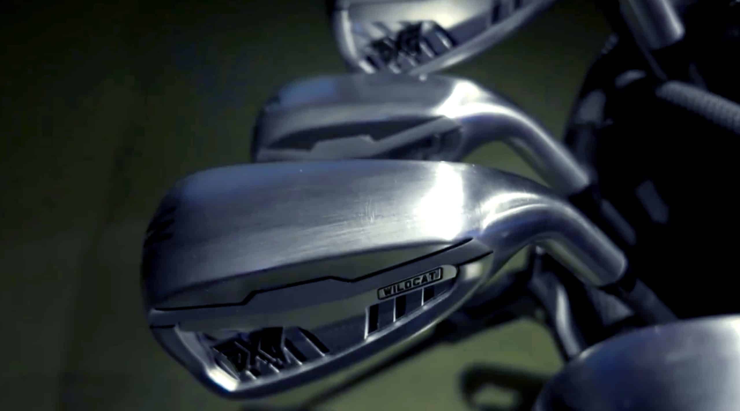 Close-up of metal golf clubs in a bag