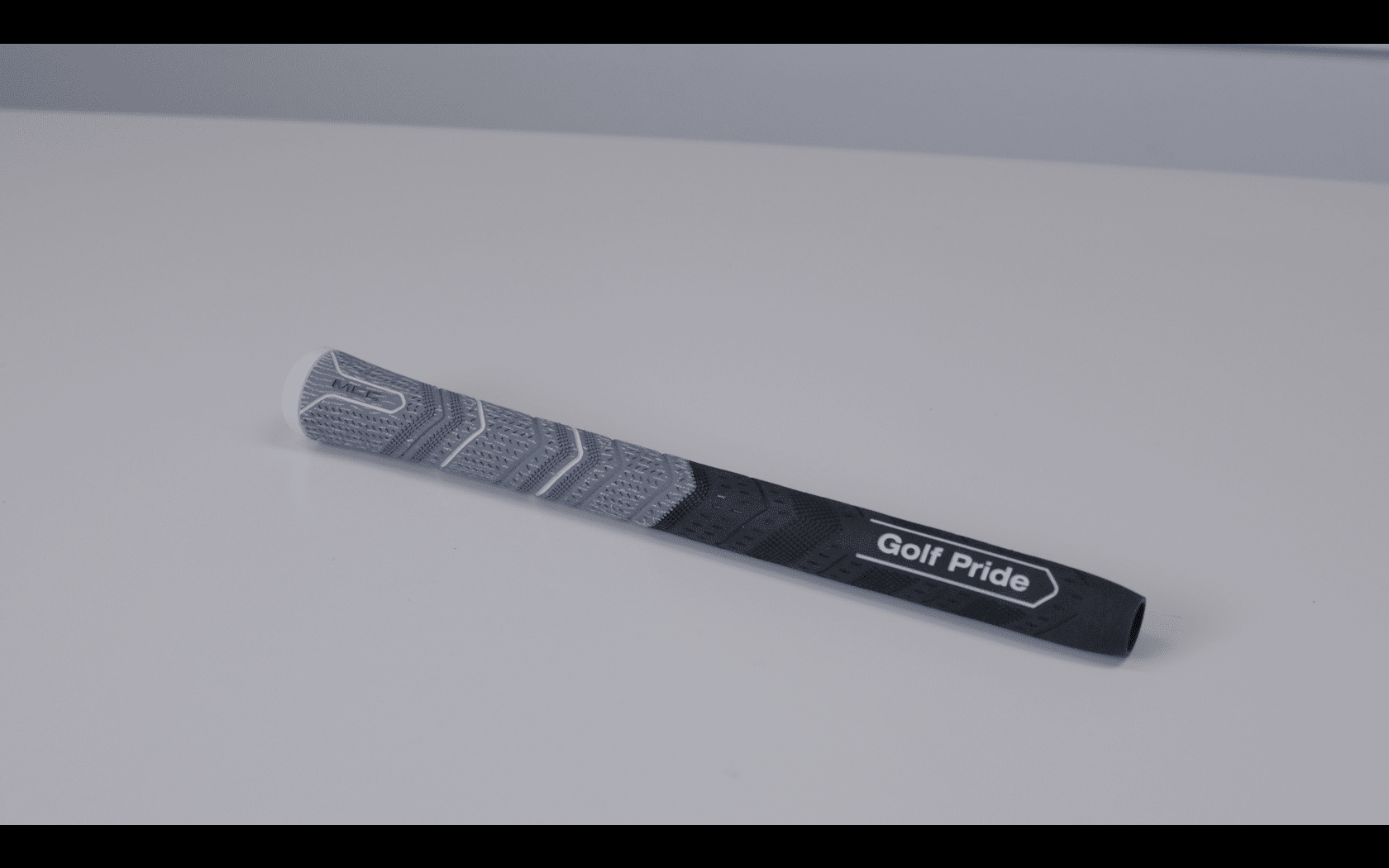 Gray Golf Pride MCC golf club grip on table
