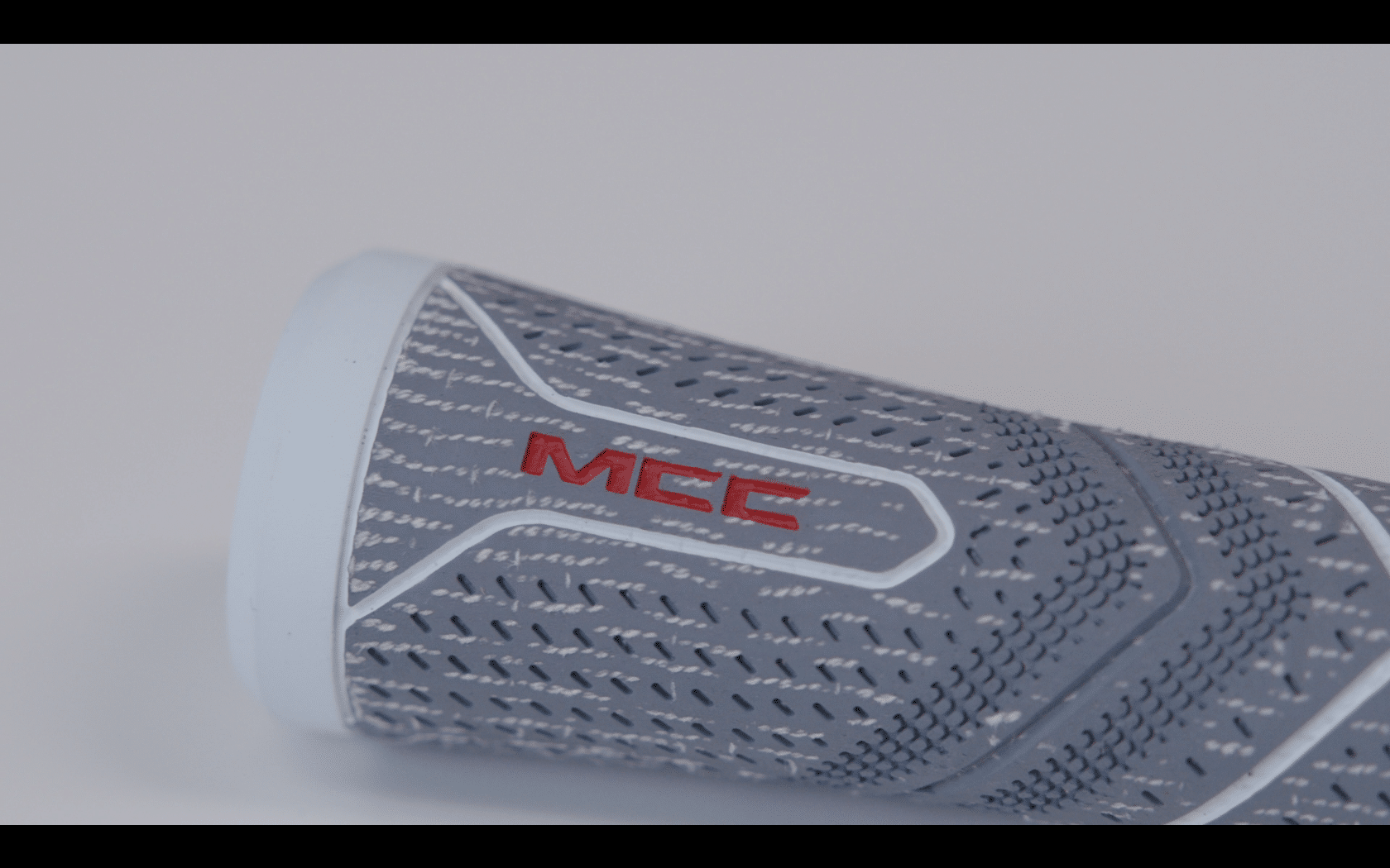 Gray textured handle grip with red MCC logo