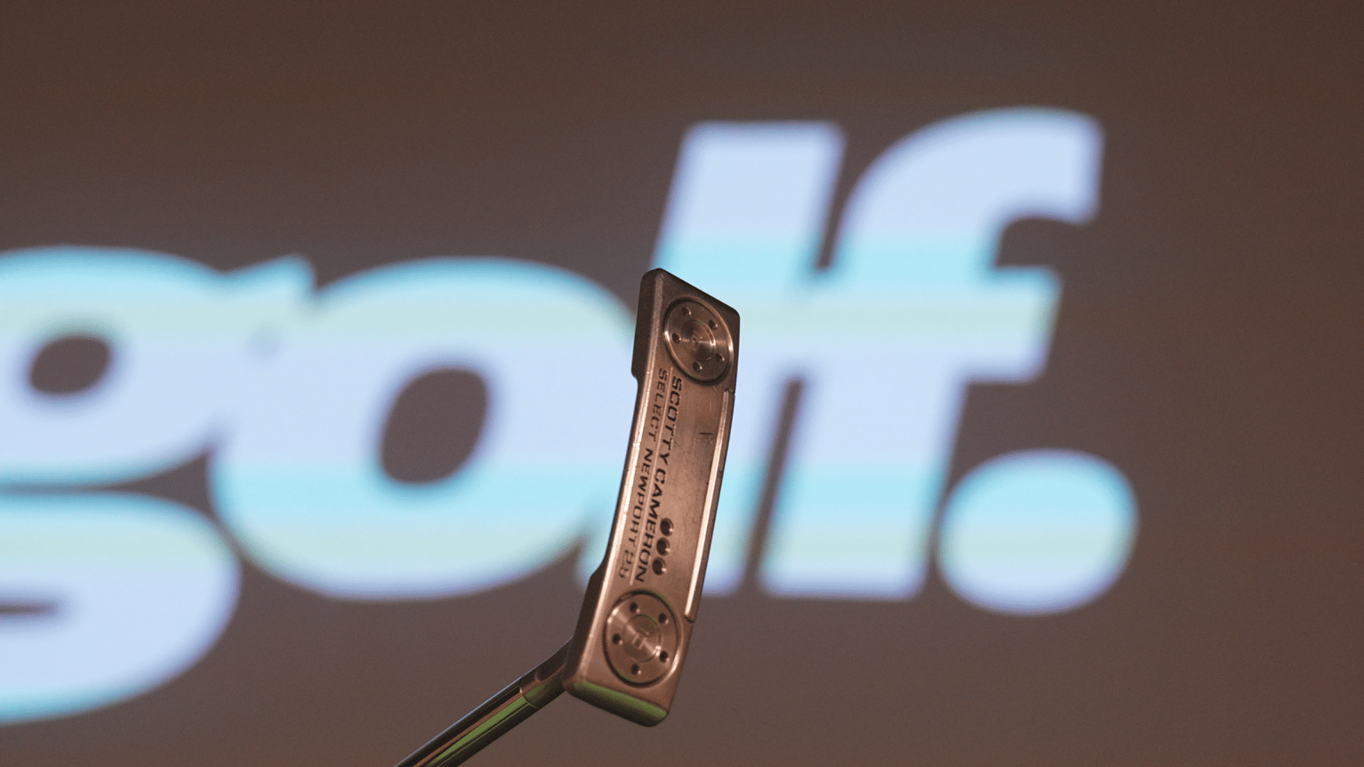 Golf putter close-up with blurred golf logo