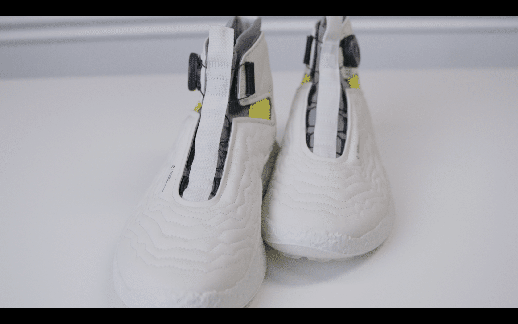 White futuristic sneakers on white surface