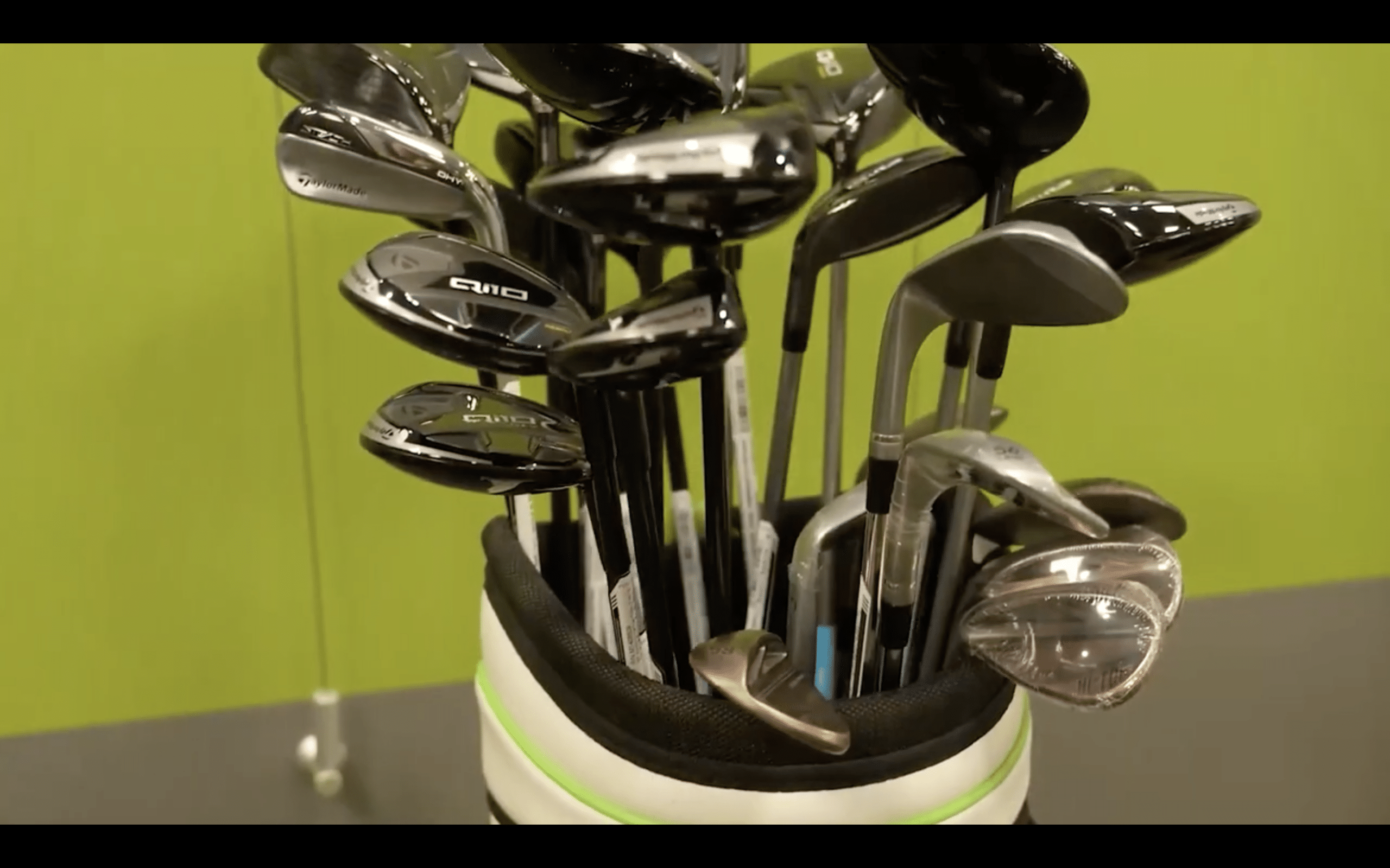 Golf bag filled with assorted golf clubs.