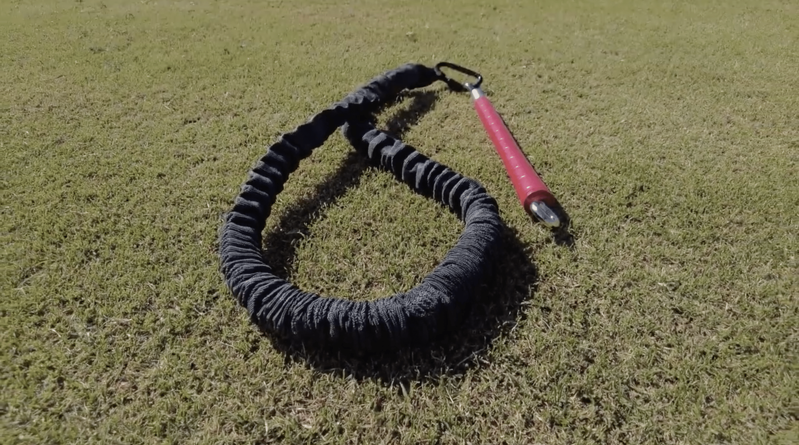 Resistance band with handle on grass field