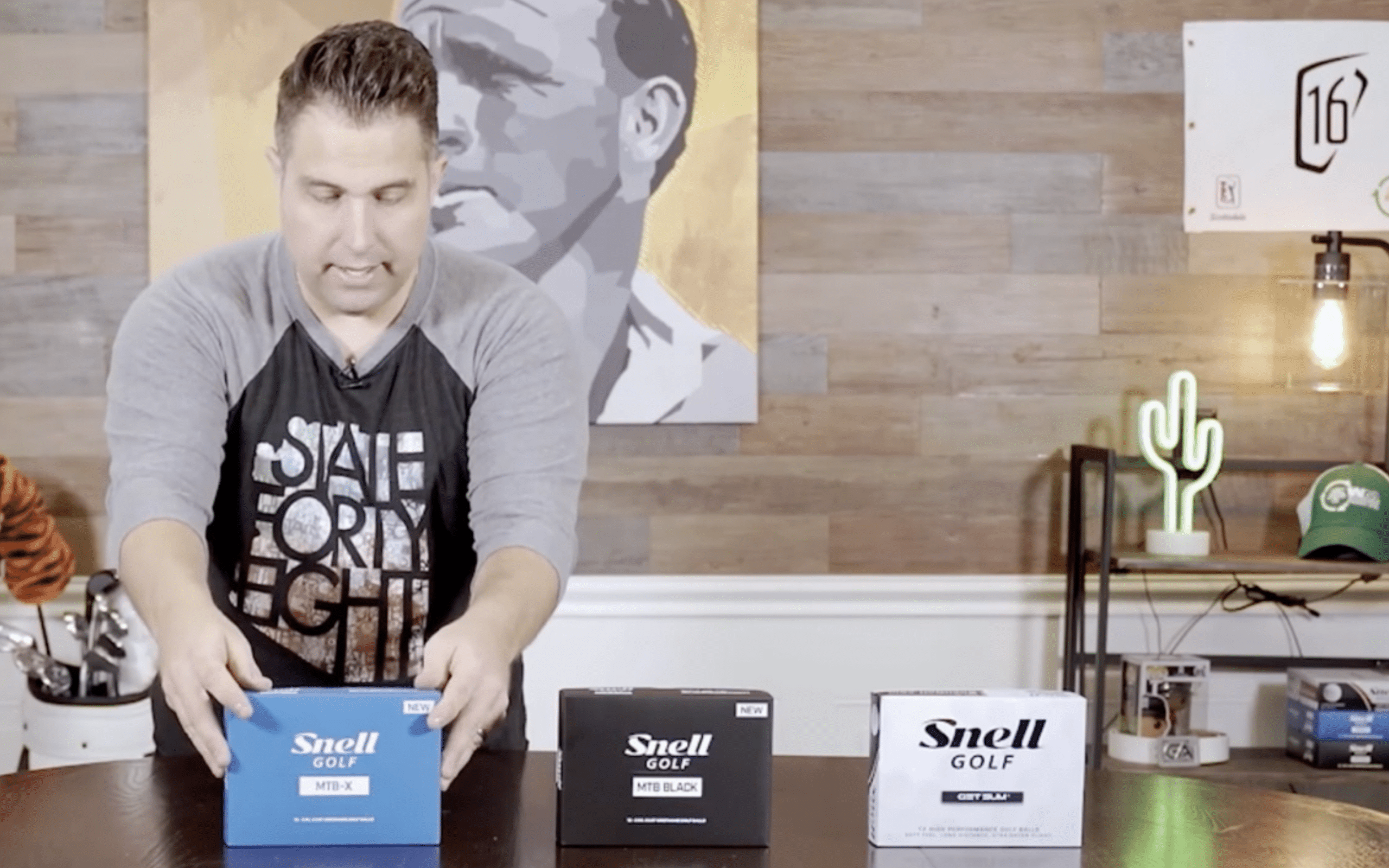 Man reviewing Snell Golf ball boxes