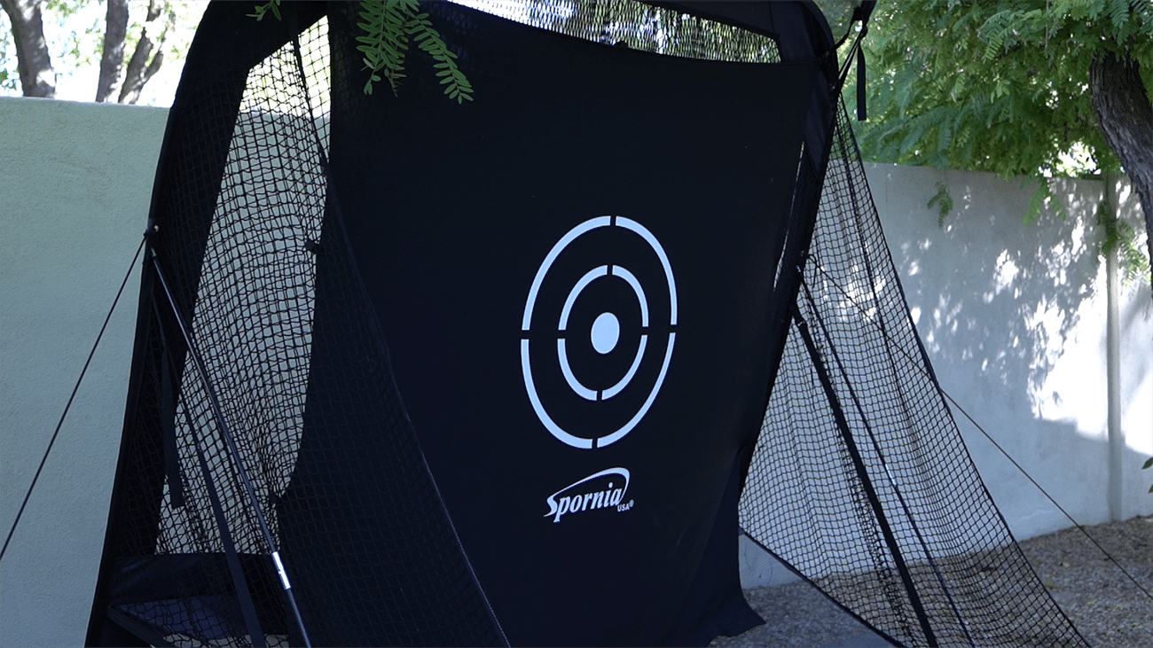 Black golf practice net with target outdoors