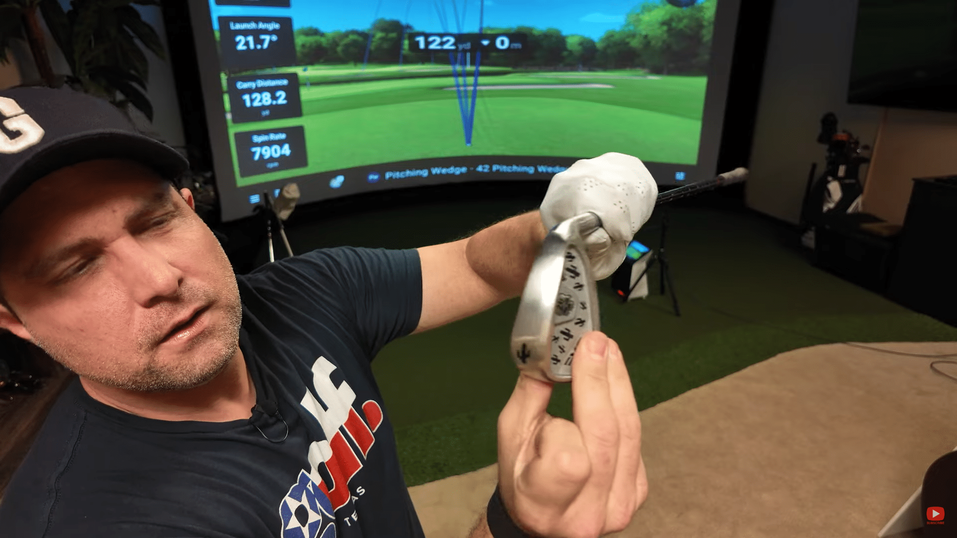 Golfer showing custom wedge in simulator room
