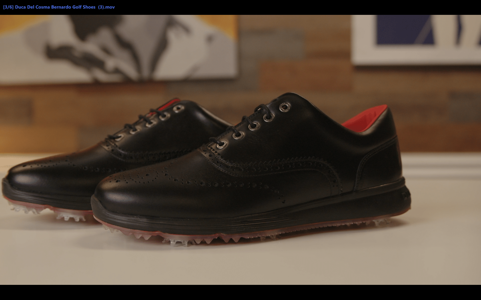 Black leather golf shoes on display table