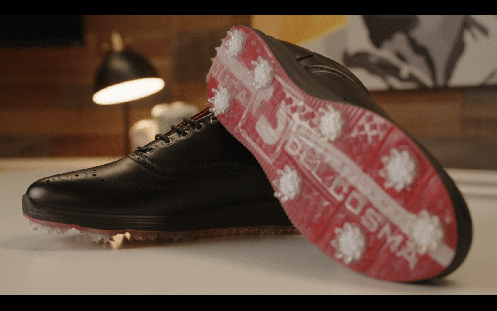 Black golf shoes with red spiked soles