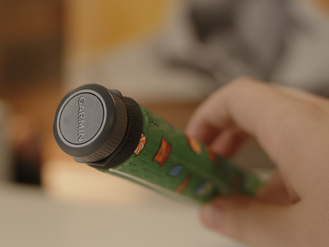 Hand holding a Garmin bike handlebar grip