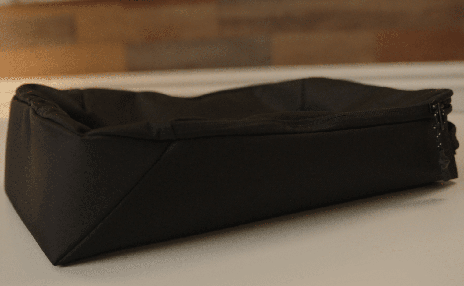 Black padded rectangular storage case on table
