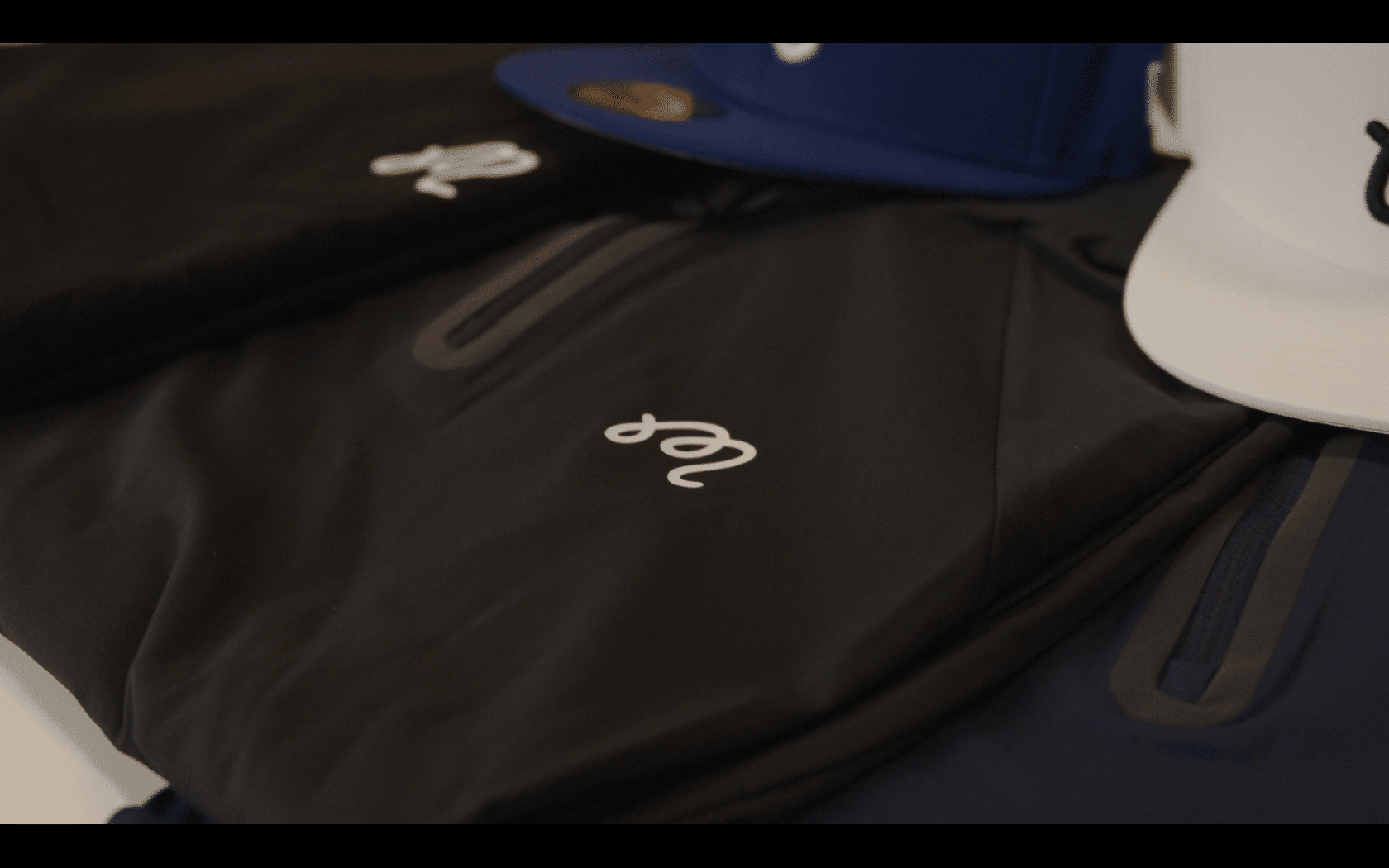 Black jackets and colorful hats on display