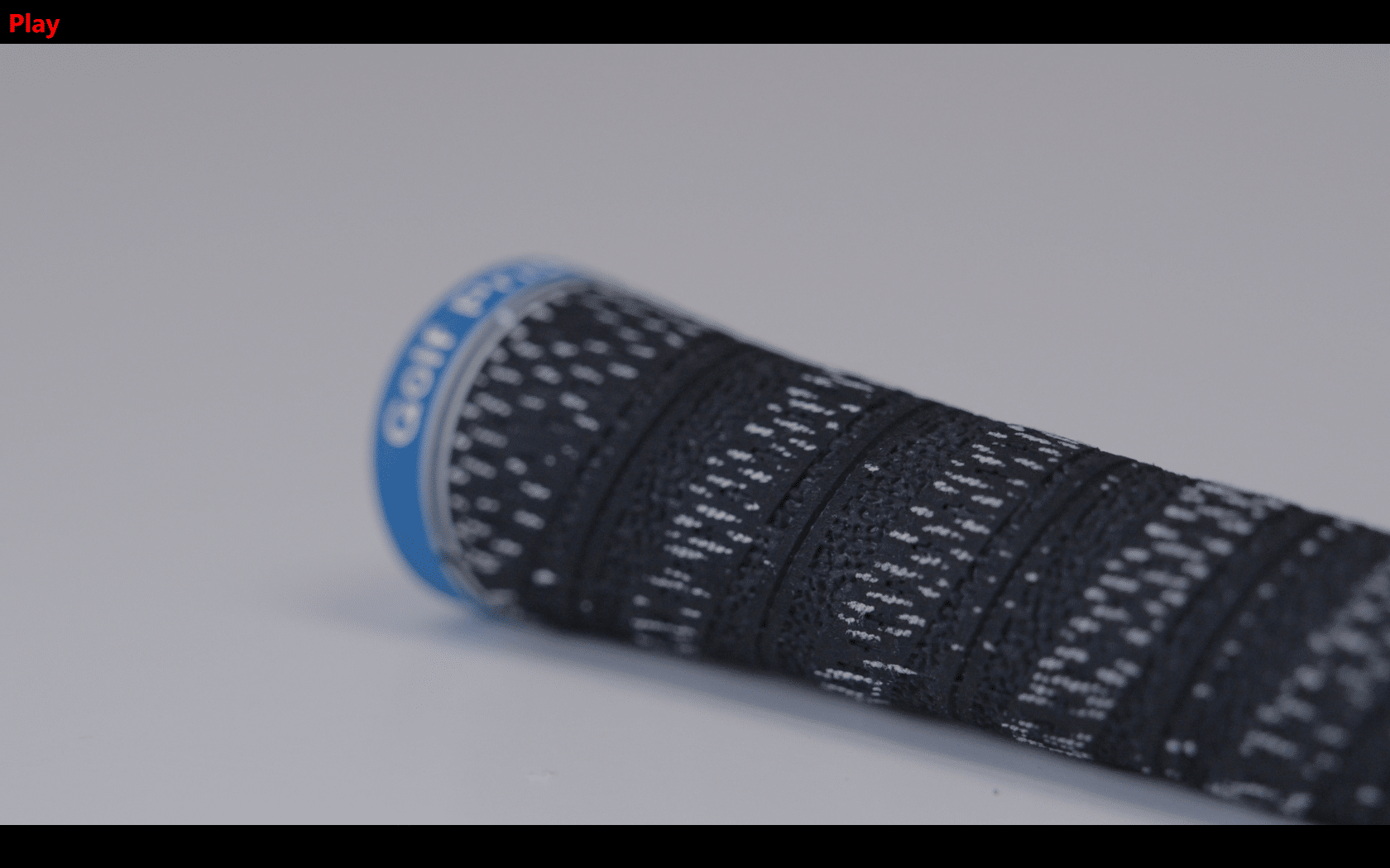 Close-up of textured black golf club grip