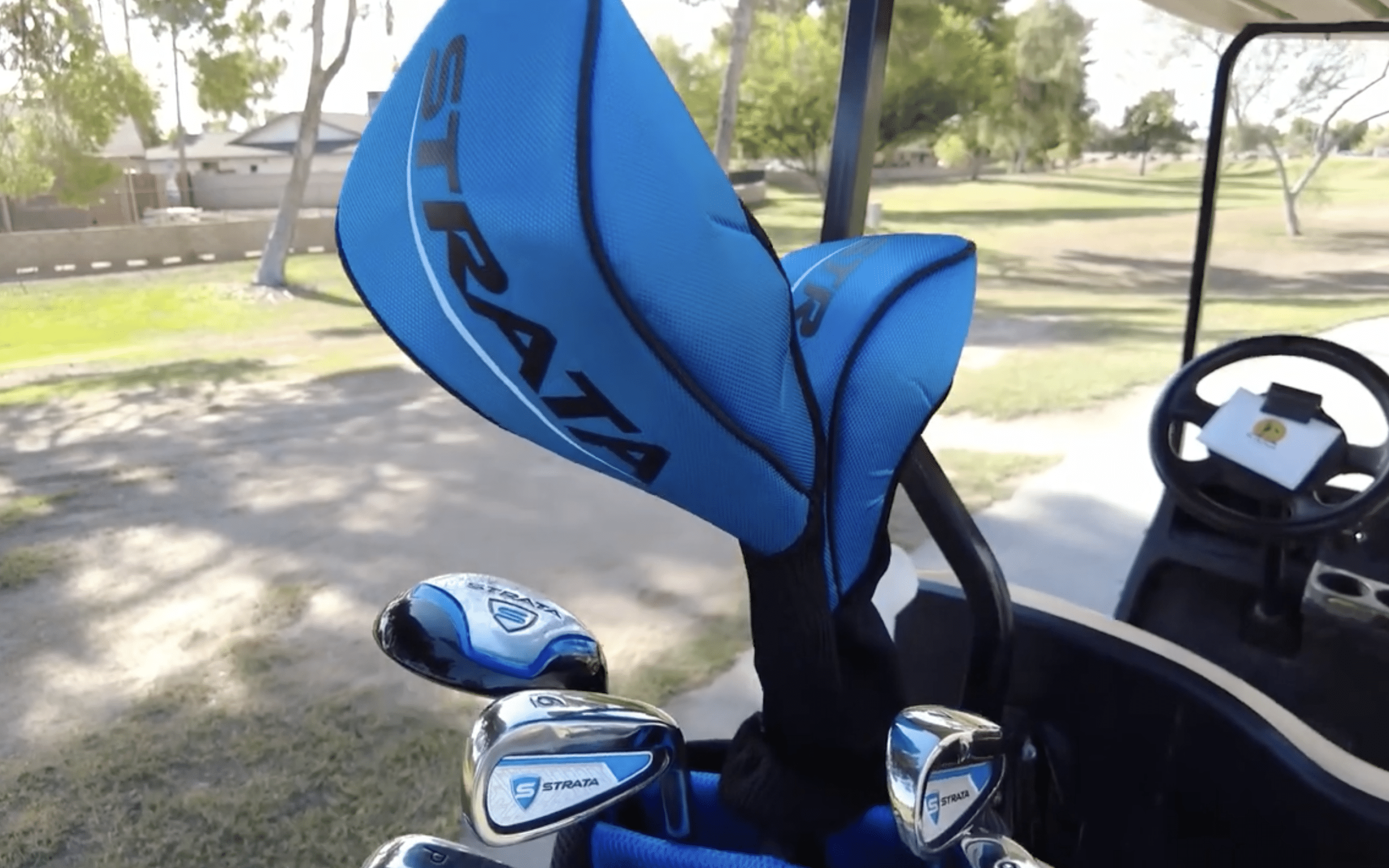 Blue Strata golf clubs in a golf cart