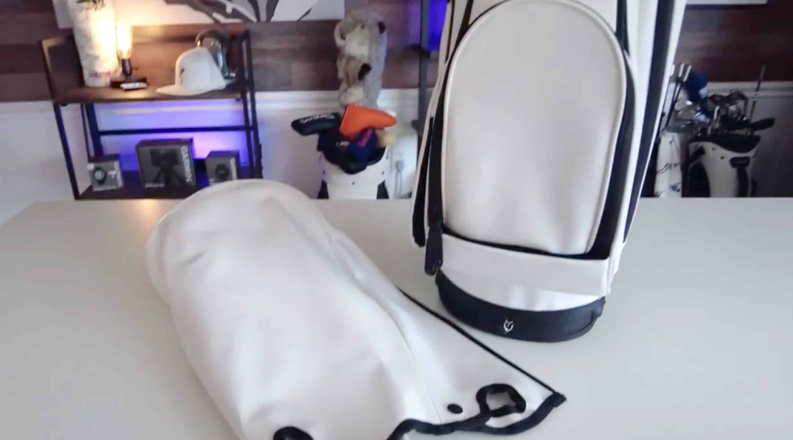 White golf bags on table in room