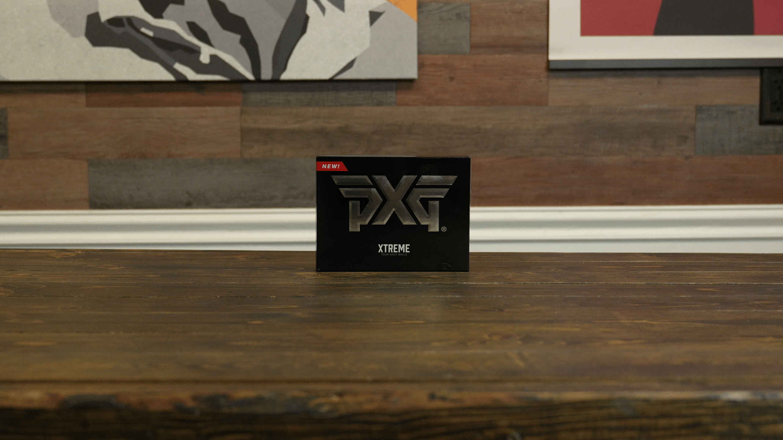 PXG Xtreme golf balls box on wooden table