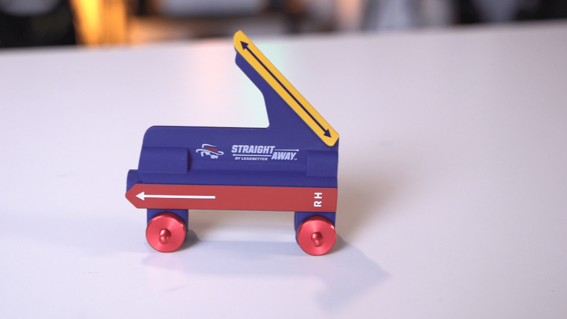 Blue golf training aid on white table