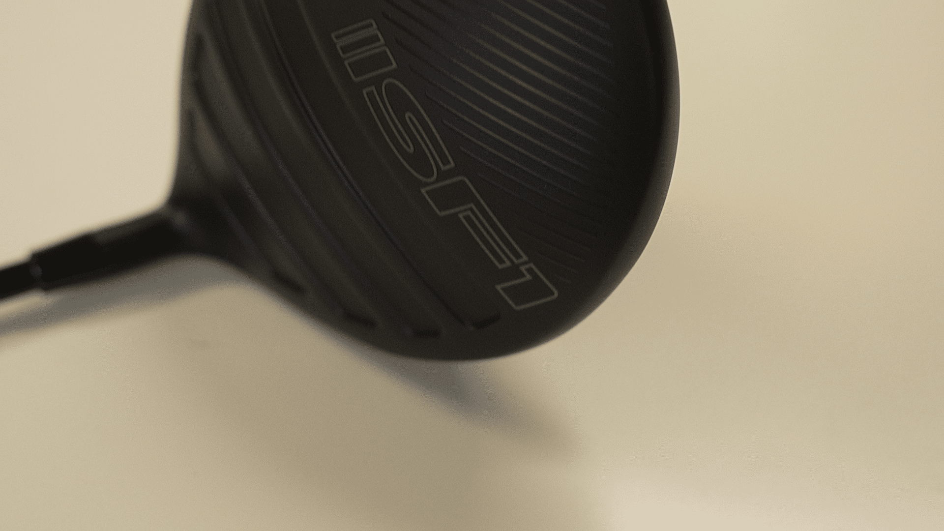 Black golf driver clubhead close-up