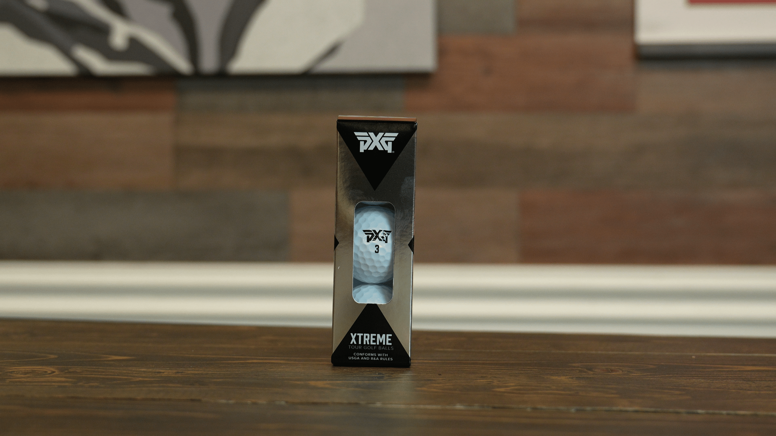 PXG Xtreme Tour golf balls box on table