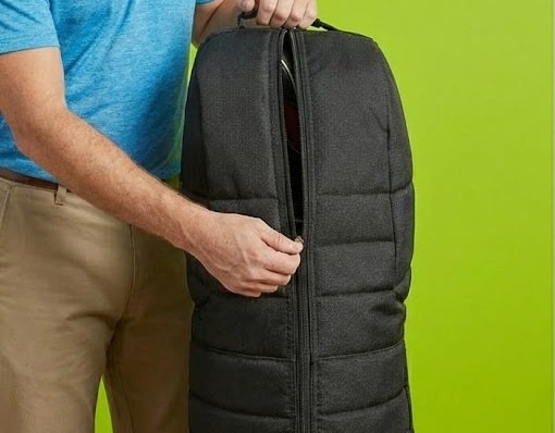 Person zipping padded black travel bag