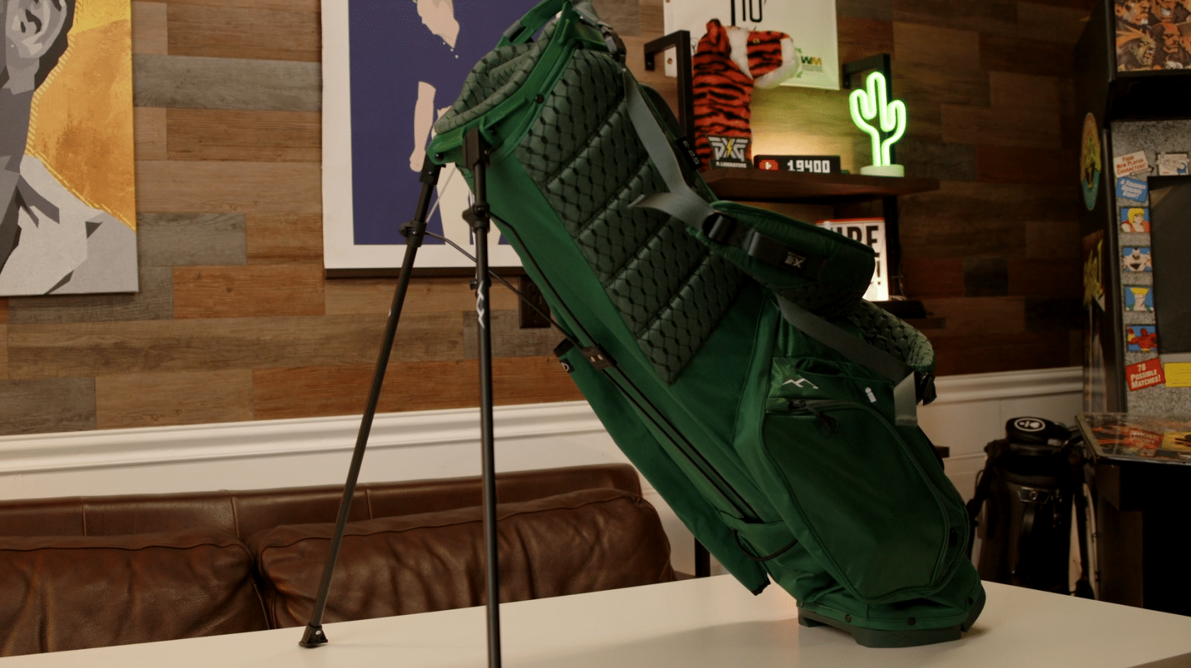Green golf stand bag with extended legs indoors