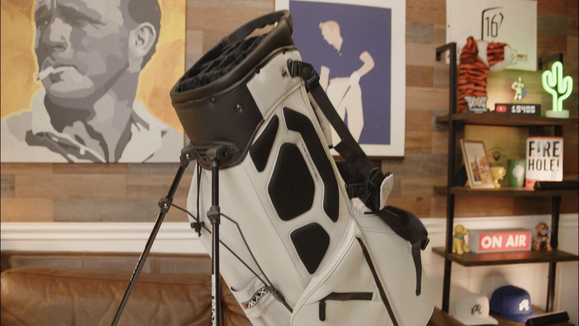 White and black golf stand bag indoors