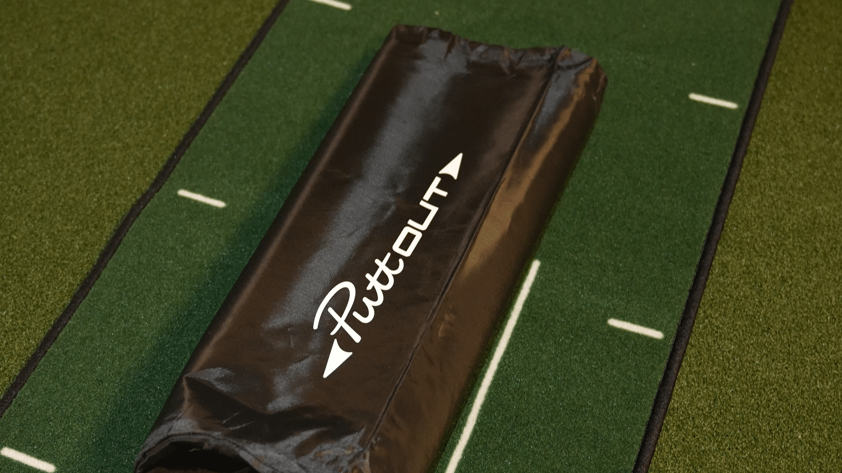 Black fitness sandbag on indoor turf field